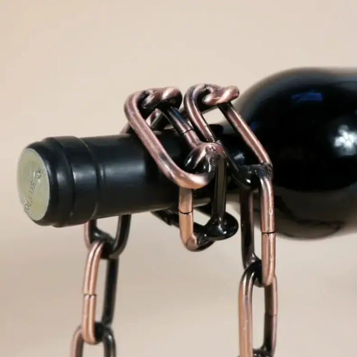 Wine bottle held by a striking Magic Iron Chain wine holder with copper-colored links